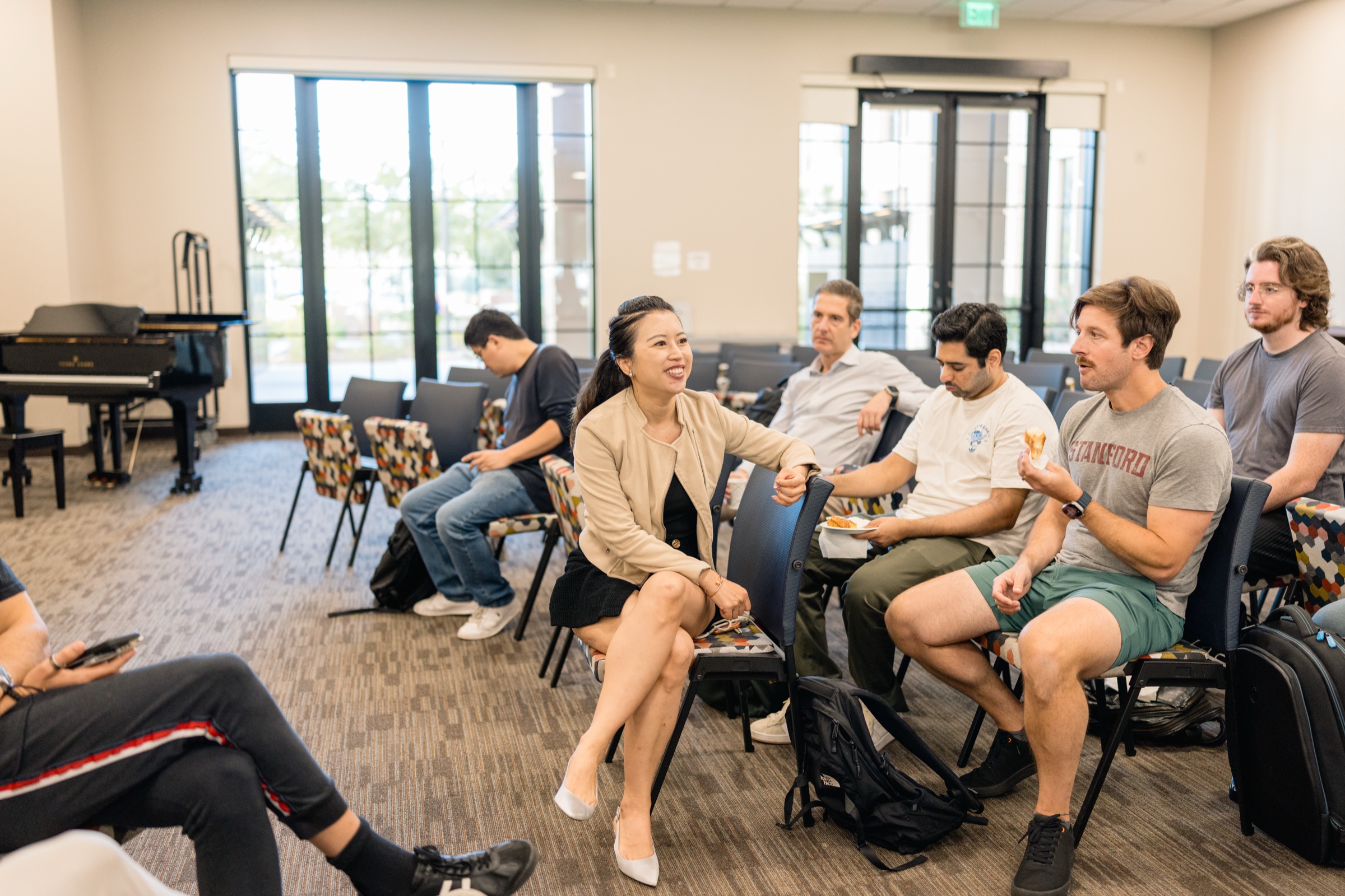 Founders talking over coffee and pastries in the breakfast room on graduation morning