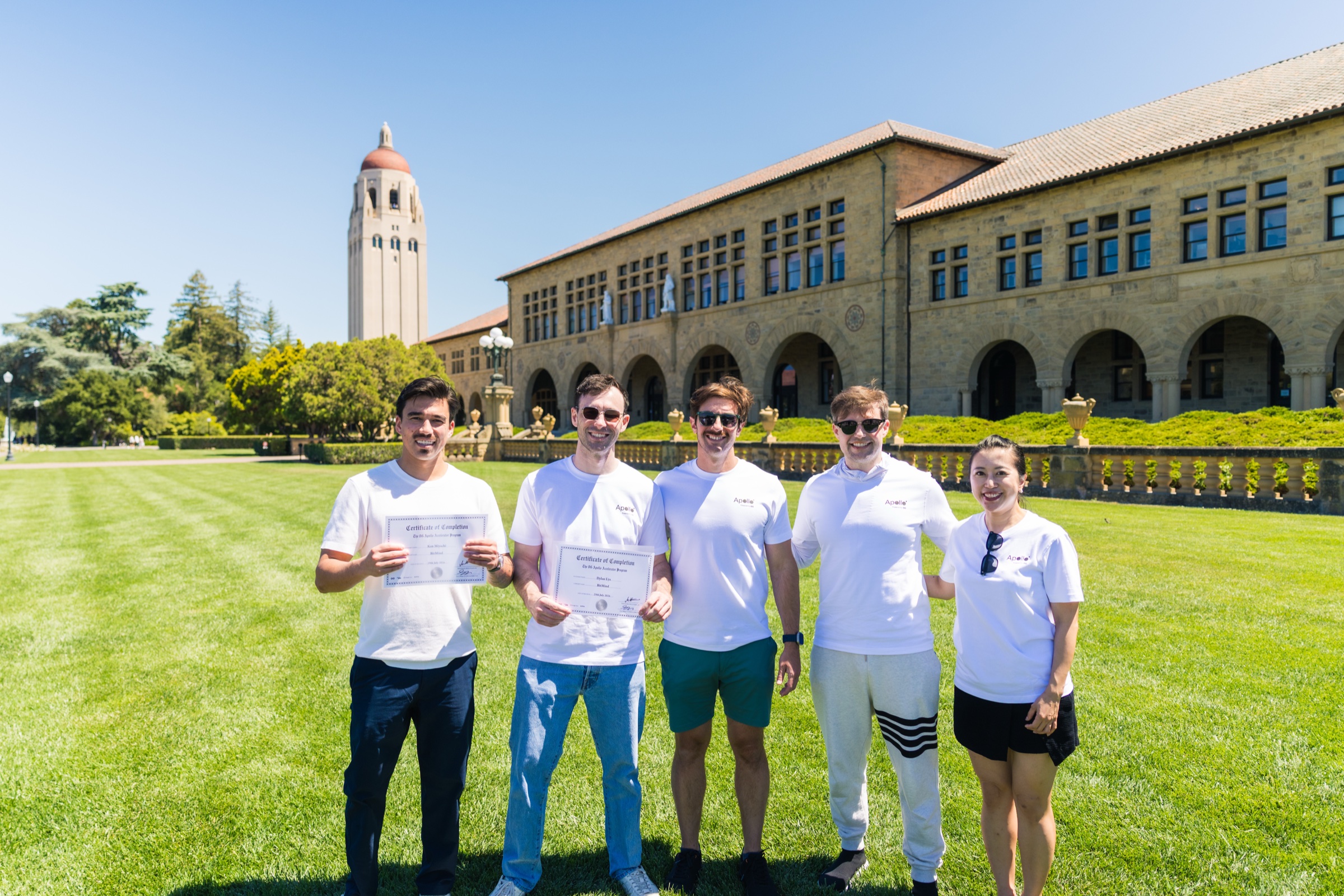 BitMind founders holding their Certificates of Completion on Stanford's Main Quad with 0G and program teammates