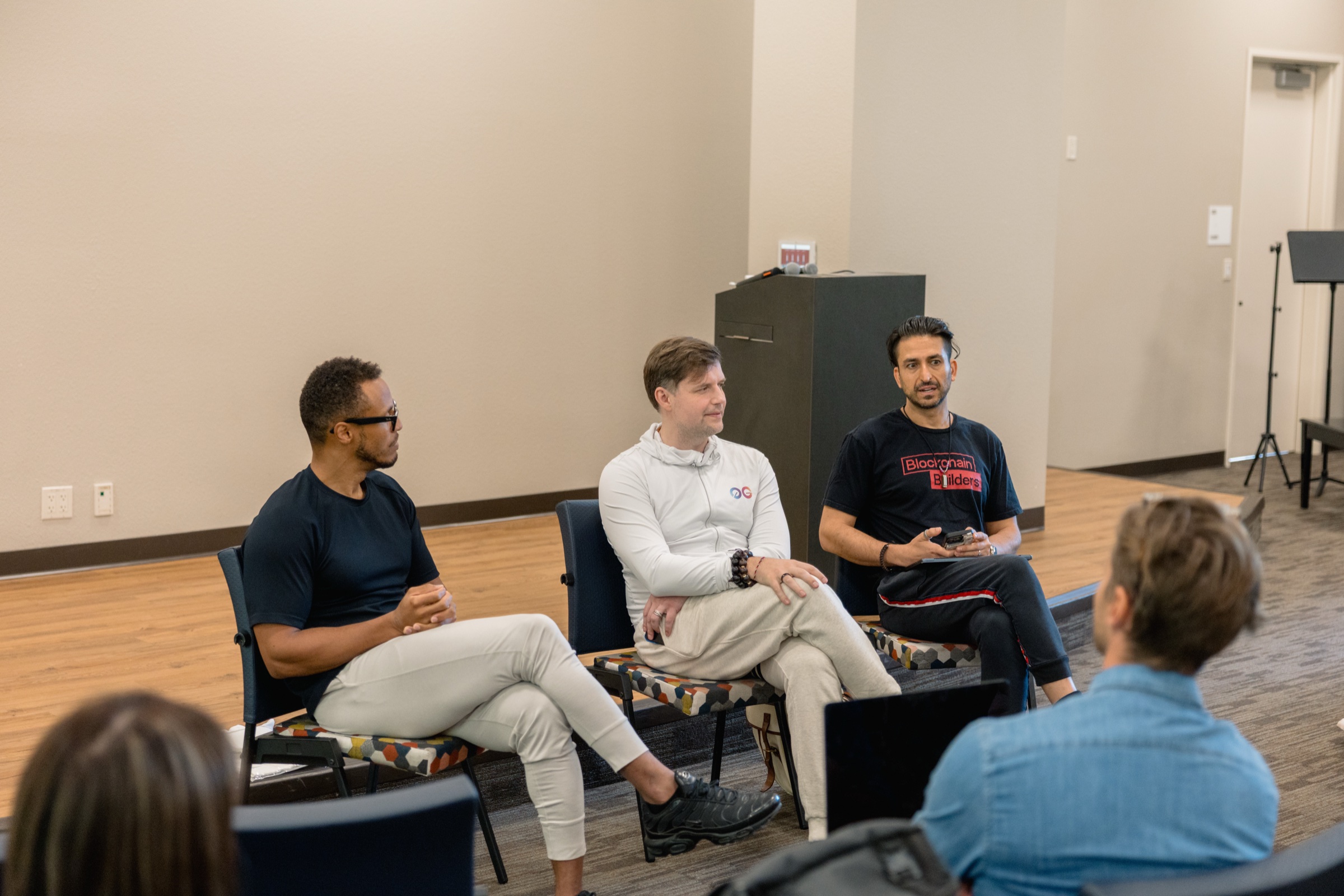 Three speakers seated on the graduation day panel about go-to-market and fundraising