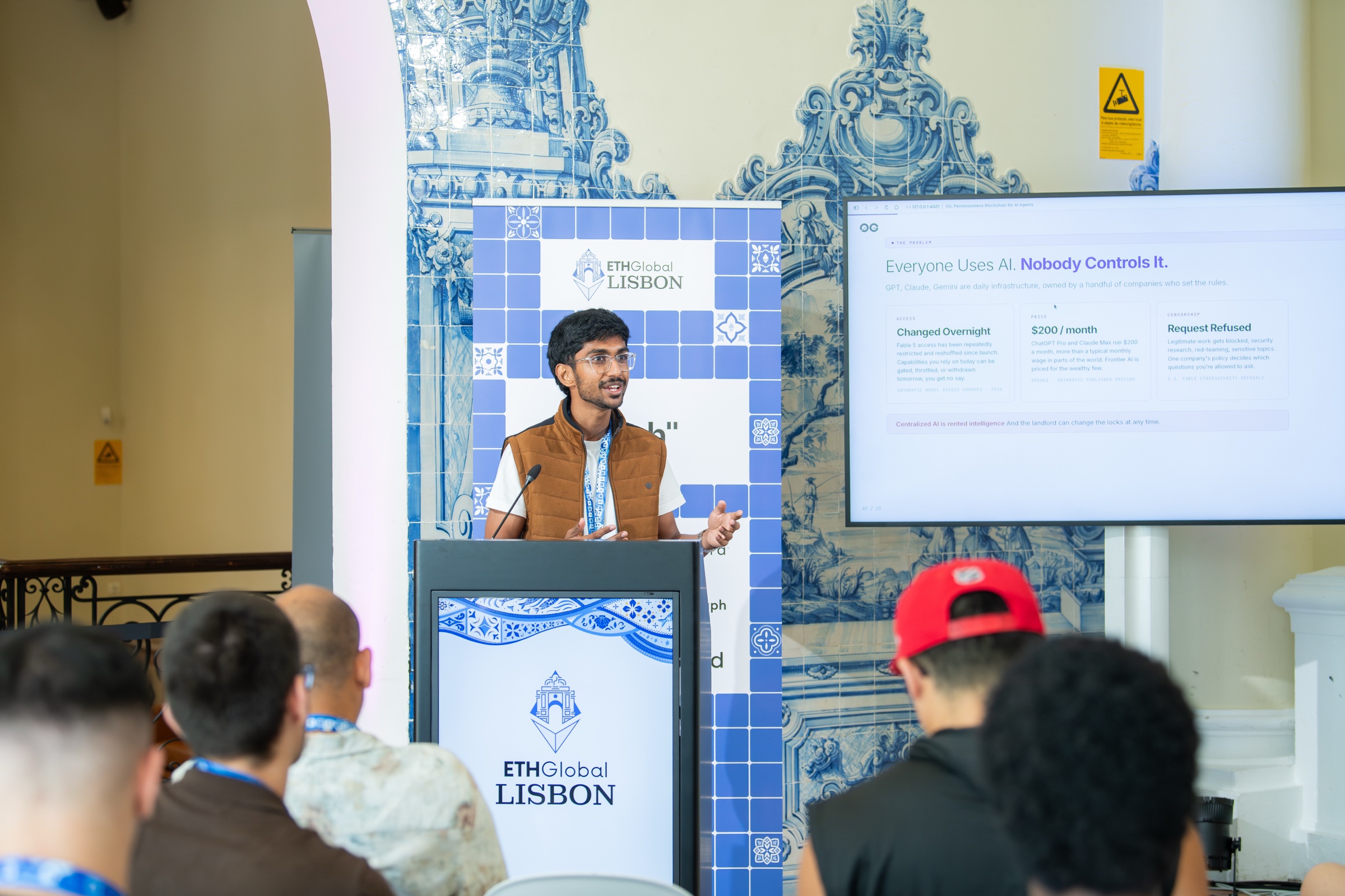 Gathin T at the ETHGlobal Lisbon podium presenting a slide reading Everyone Uses AI Nobody Controls It