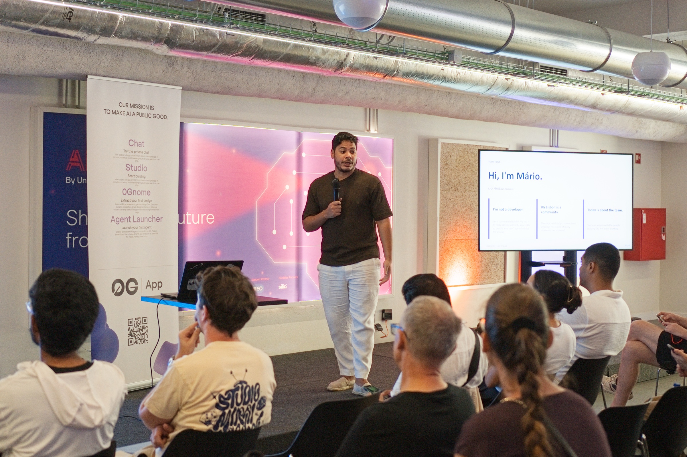 Mario speaking on stage next to a slide reading Hi, I'm Mario at the House of AI Demo Day